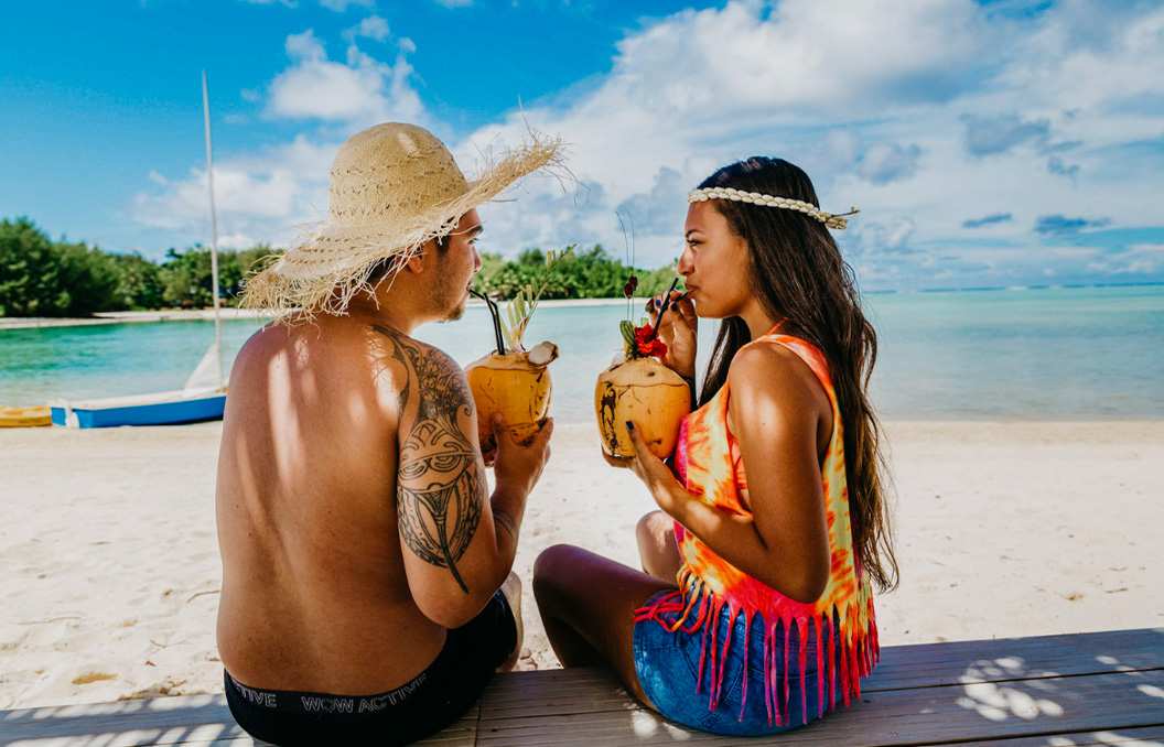 Muri Beach Club Rarotonga - couple enjoys fresh coconut drinks